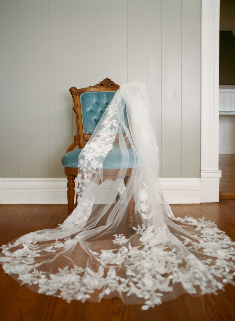 Bridal veil draped over vintage blue chair at The Allen Farmhaus, photographed on 120 film