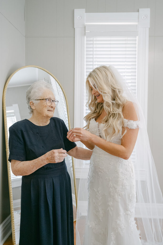 Bride sharing a joyful moment with grandmother while getting ready at The Allen Farmhaus