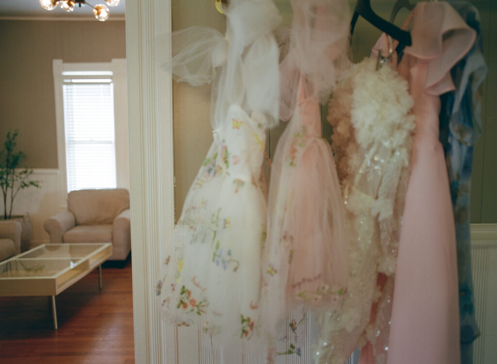 Flower girl dresses hanging in hallway at The Allen Farmhaus, photographed on 120 film