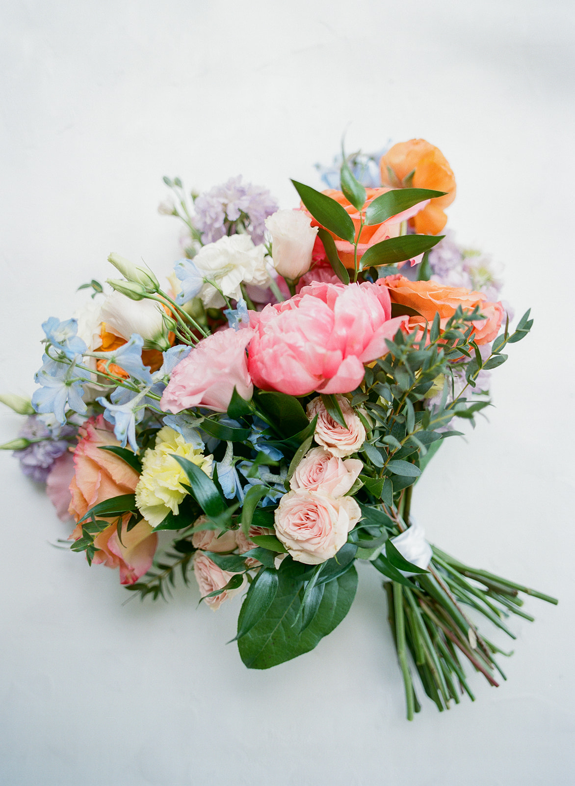Colorful bridal bouquet captured on 120 film with peonies, roses, and pastel florals at The Allen Farmhaus wedding in New Braunfels