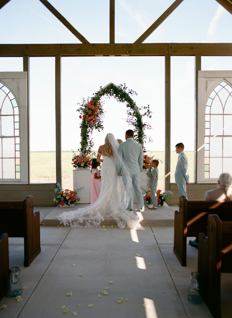 Bride and groom walking up to the altar during ceremony at The Allen Farmhaus, photographed on film